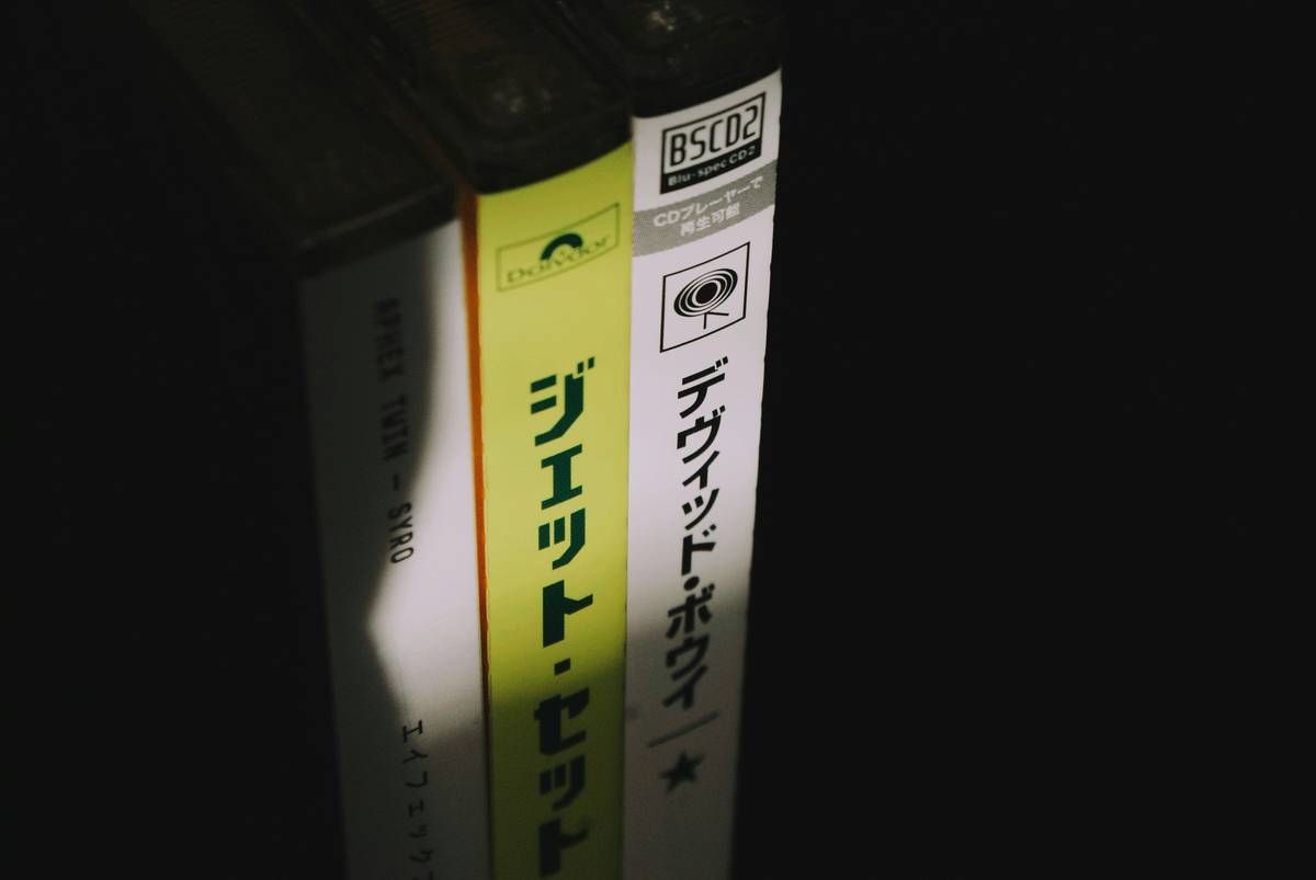 Close-up of psychological horror japanese novels open on a dimly lit desk